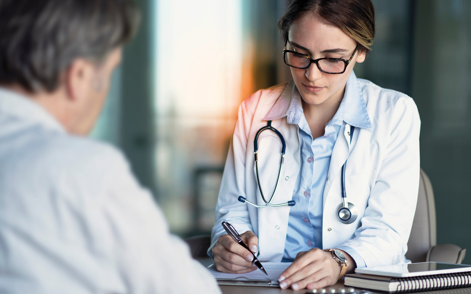 A doctor sitting with a patient