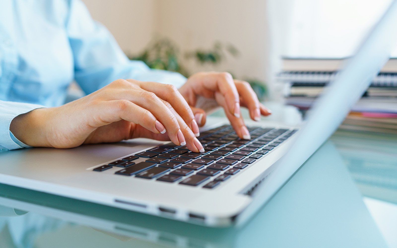hands typing on laptop