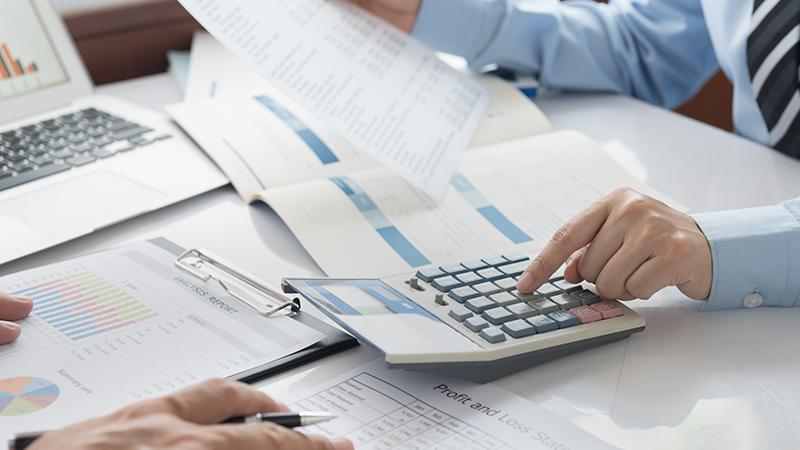 Business man using calculator